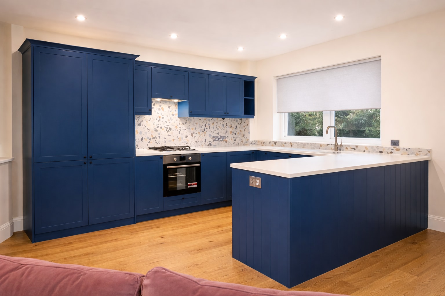 Blue kitchen cabinetry and island in an E14 flat