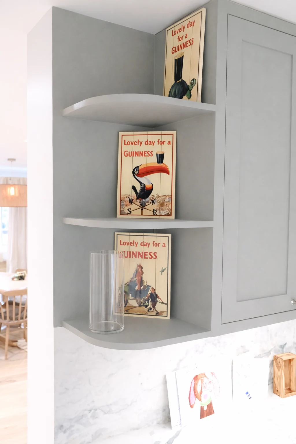 Open corner shelving beside a glazed kitchen cupboard