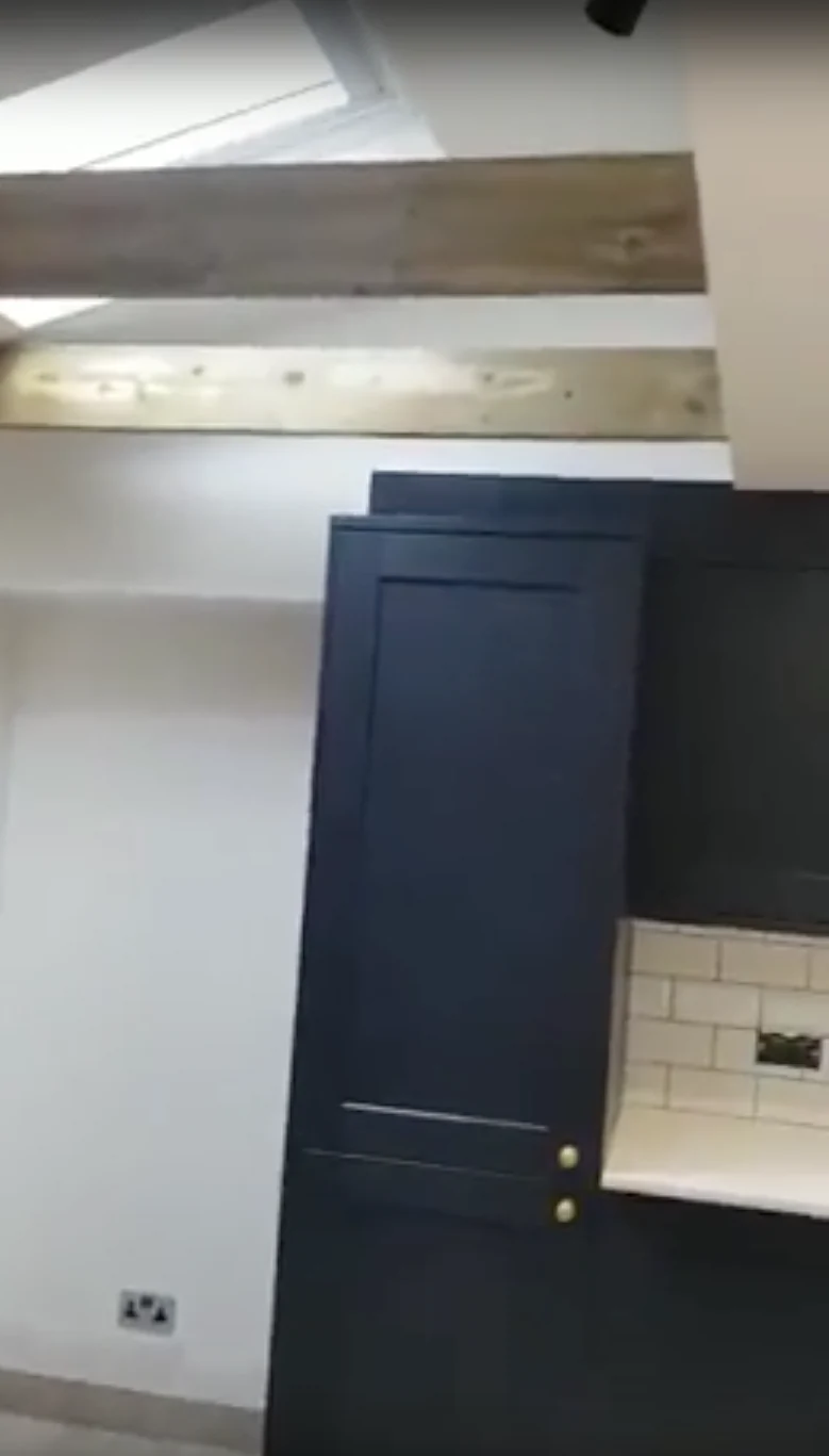 Roof glazing and an exposed ceiling beam above the kitchen