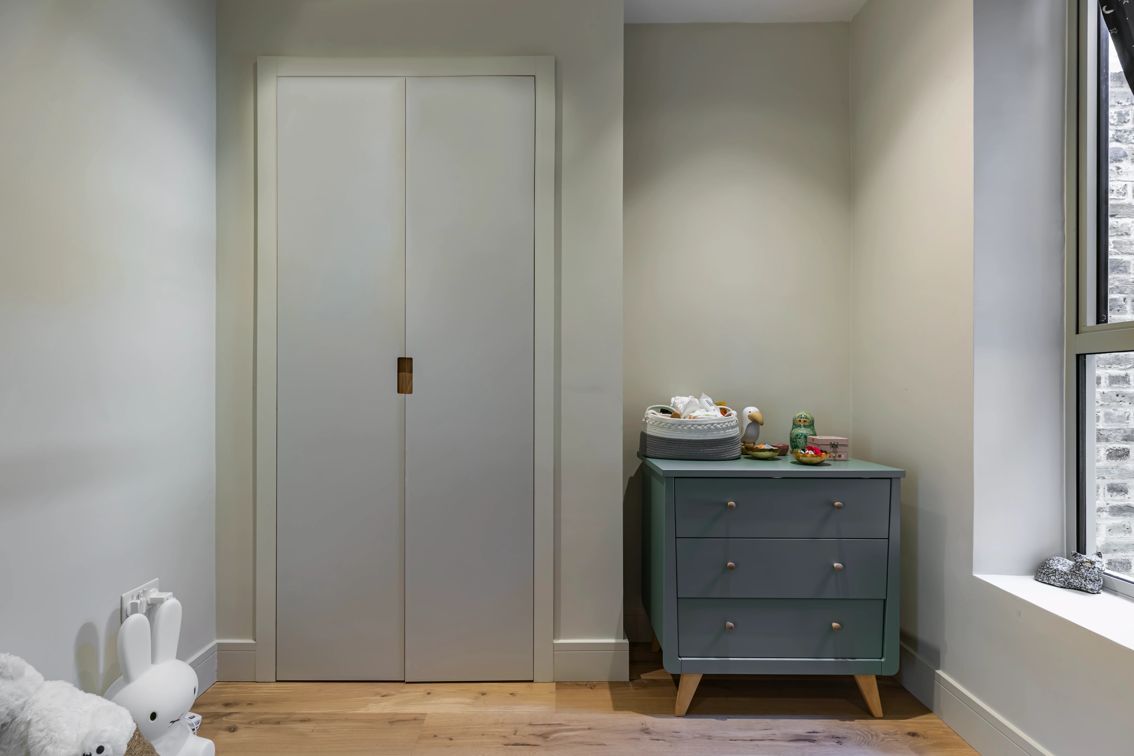 Fitted cupboard within a bedroom alcove.