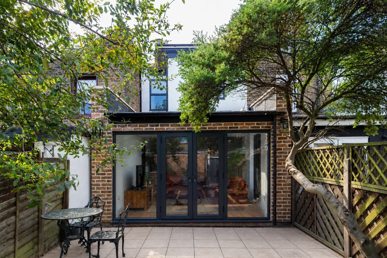 Rear extension with dark framed doors opening to the garden