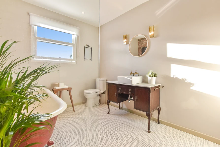 Bathroom vanity and window with pale wall finishes