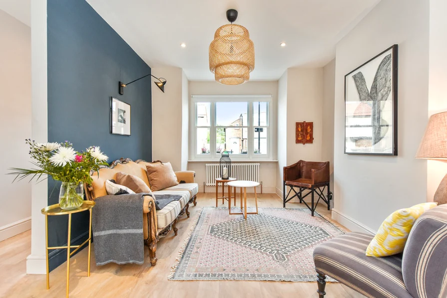 Living room with a blue feature wall and window-side seating